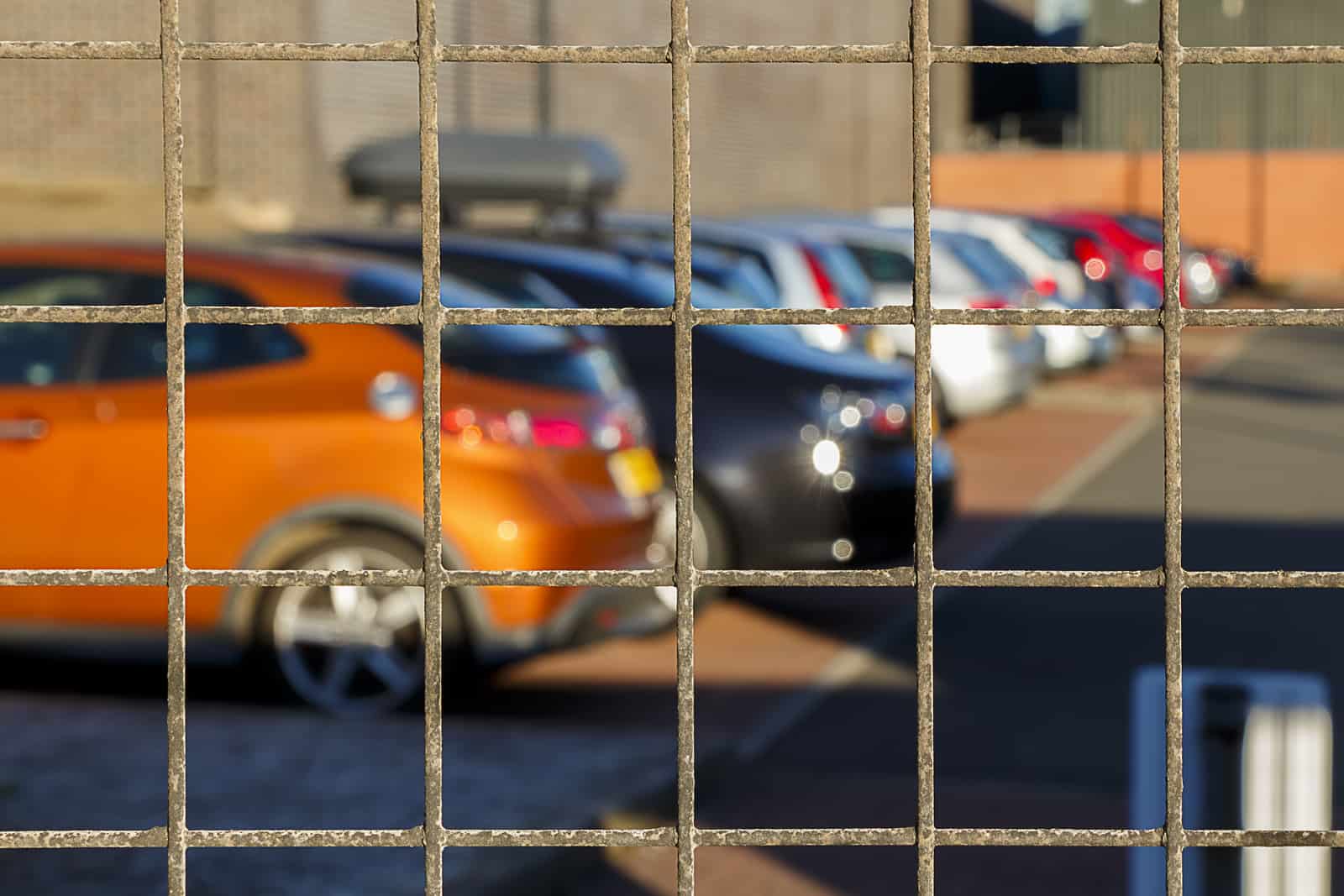 A line of cars behind fence from being impounded after a dui arrest