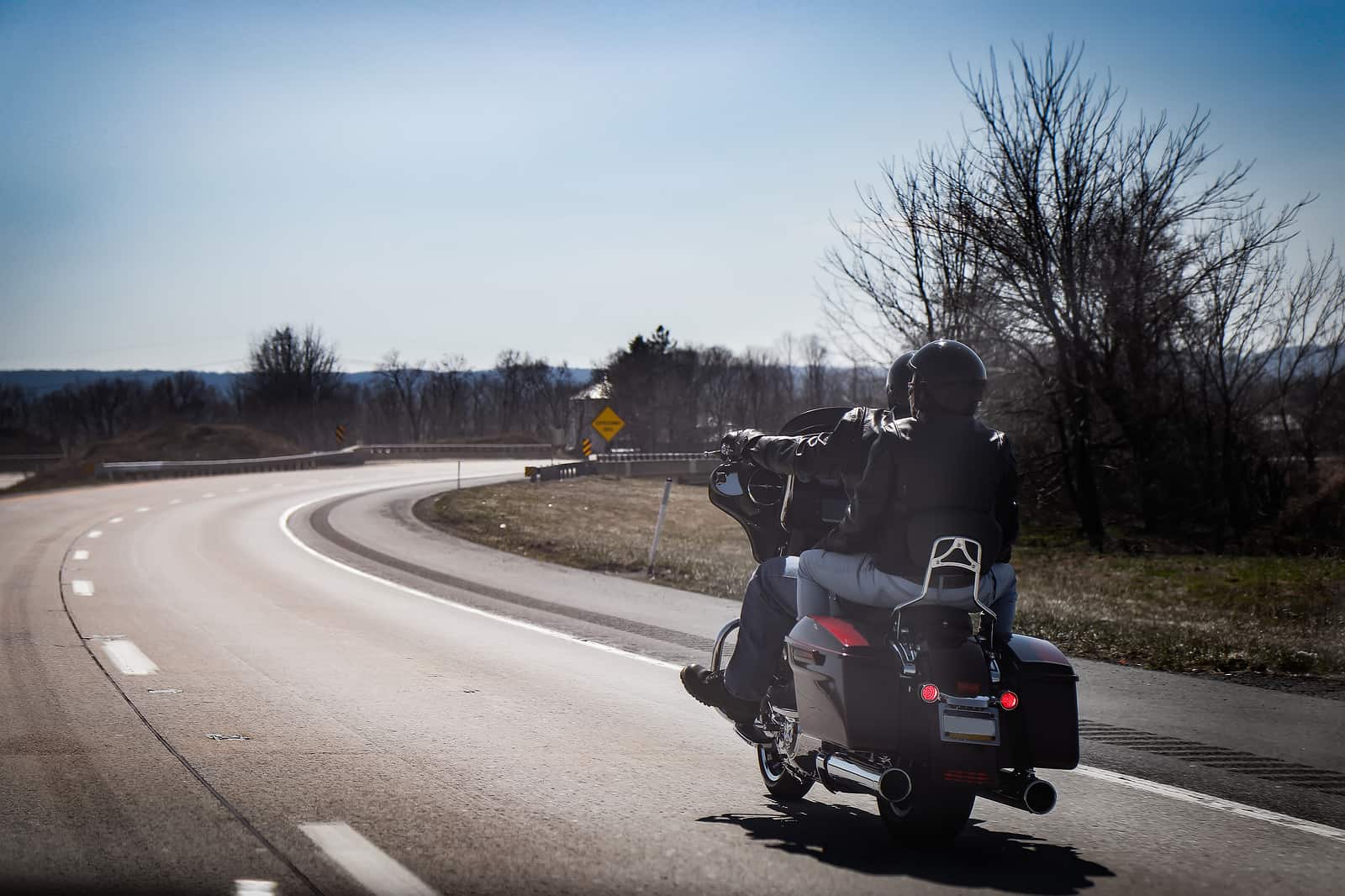 A couple rides a motorcycle together