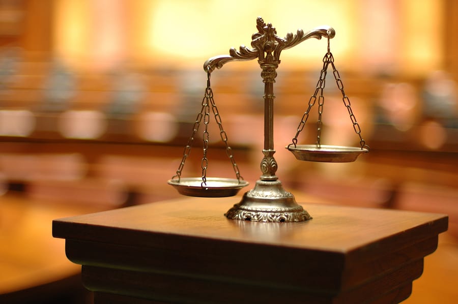Scales symbolizing justice with a private criminal defense attorney